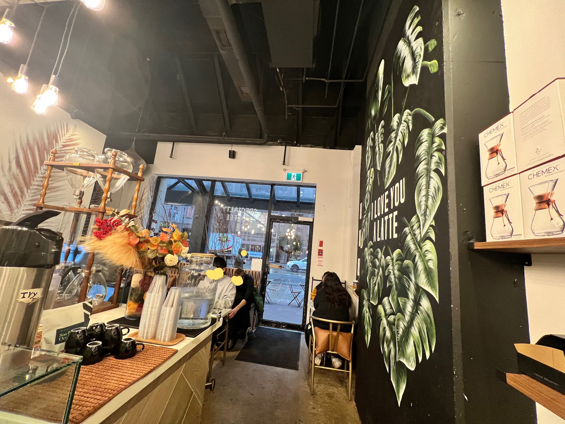 Cafe interior with mural wall and seated customers